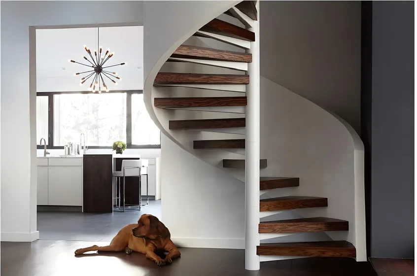 Curved open-riser stair, walnut treads on a plastered spine (ST-05)